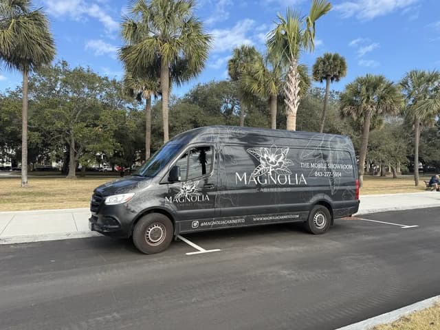 Magnolia mobile showroom parked outside a home
